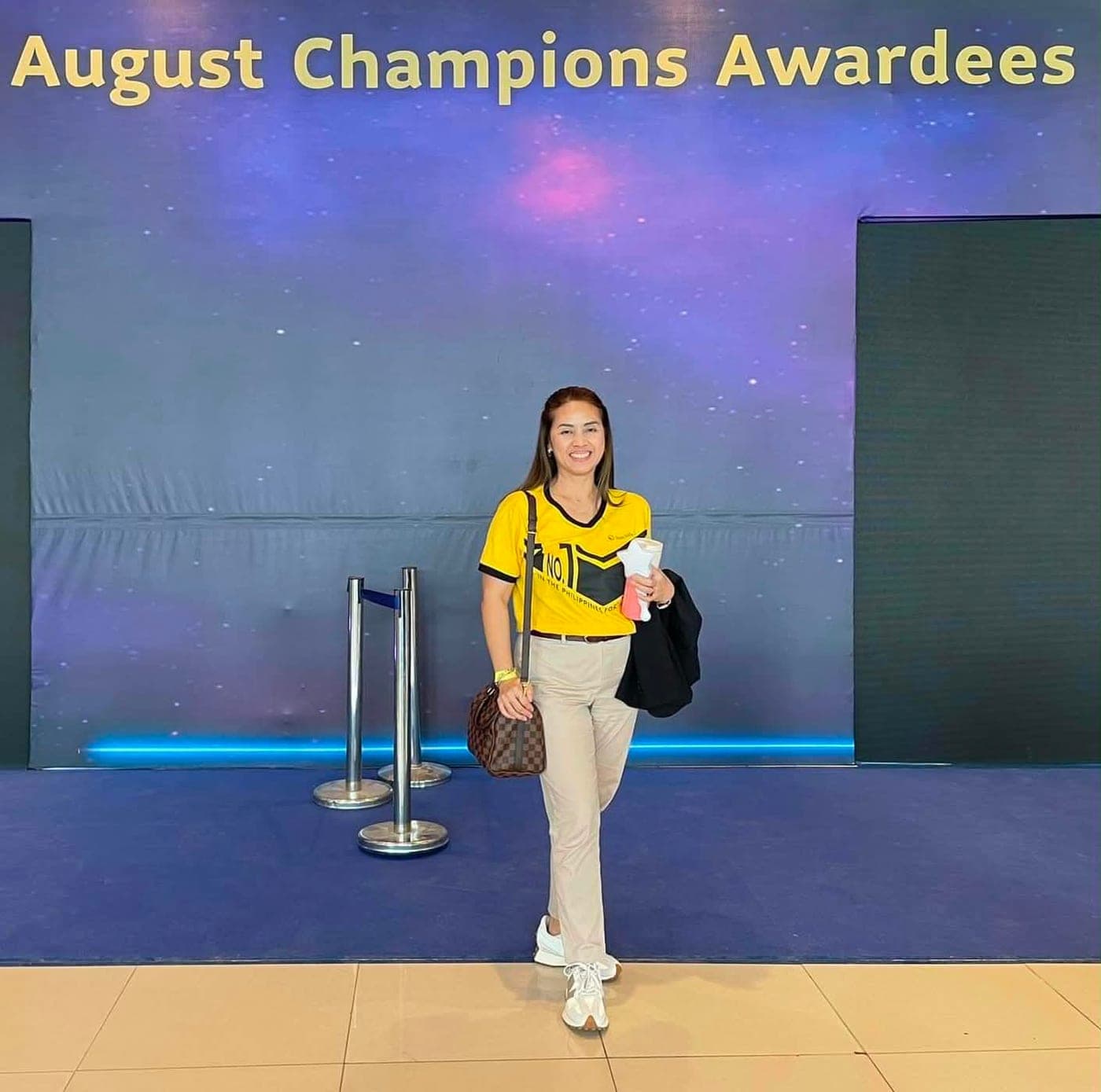 Ruth Abestilla at the Sun Life August Champions Awardees stage